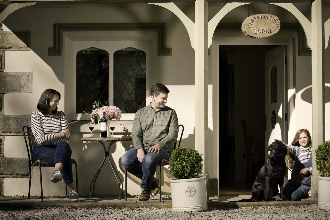 family playing with black labrador at house in tyrone